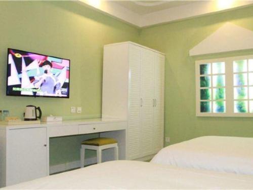 a bedroom with a bed and a tv on the wall at TO915101 STILL LOVE THEME HOTEL in Chengdu