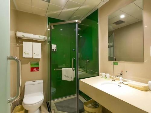 a bathroom with a shower and a toilet and a sink at Vatica JiangsuJianguo Road Xuanwu Market Hotel in Xuzhou