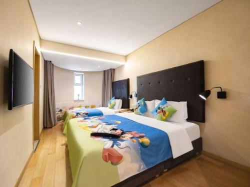 a bedroom with a large bed with a cow on it at Yitel Shenyang Sanhao Street Shengjing Hospital in Shenyang