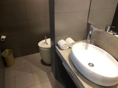 a bathroom with a sink and a toilet at Yitel Shenyang Sanhao Street Shengjing Hospital in Shenyang