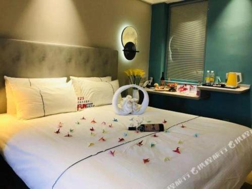 a bedroom with a large bed with stars on it at Magnotel Hotel Suzhou Guanqian Street Pingjiang Road in Suzhou