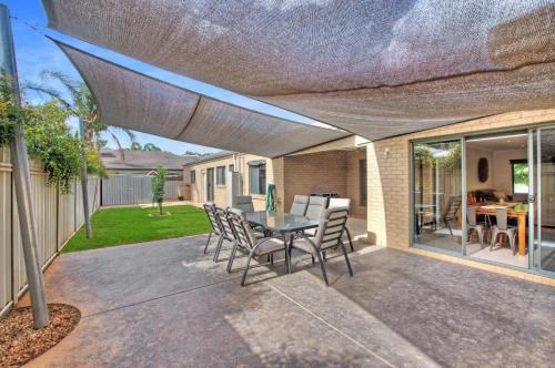 a patio with a table and chairs under awning at Parkview - Echuca Holiday Homes in Moama