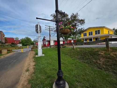 a pole with a flower basket on it on a street at 1878 RiverRun B&B - Waterfront, Self-Serve Breakfast, WiFi, Trail and River access in Hancock