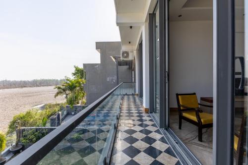 a balcony with a view of the beach at Heartland- Ganga Villa with Jacuzzi and private lift in Rishīkesh
