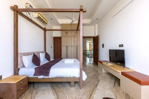a bedroom with a bunk bed and a television at Heartland- Ganga Villa with Jacuzzi and private lift in Rishīkesh