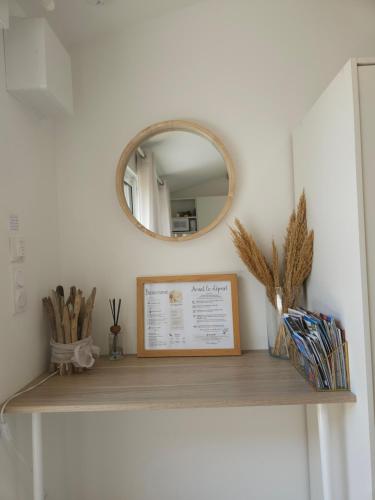 a mirror on a shelf in a room at Havre de paix climatisé vers Gordes - Spa & nature in Beaumettes