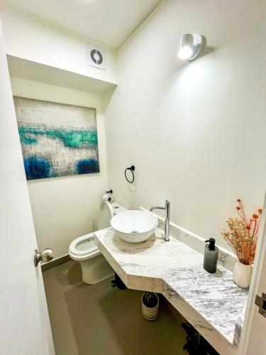 a bathroom with a sink and a toilet at Ocean view 1 BR Miraflores with parking in Lima