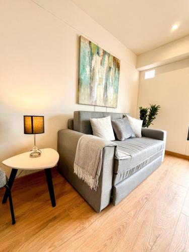 a living room with a couch and a table at Ocean view 1 BR Miraflores with parking in Lima