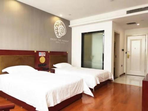 Ένα ή περισσότερα κρεβάτια σε δωμάτιο στο Shell Hotel Liaocheng Dongchang Xi Road Railway Station