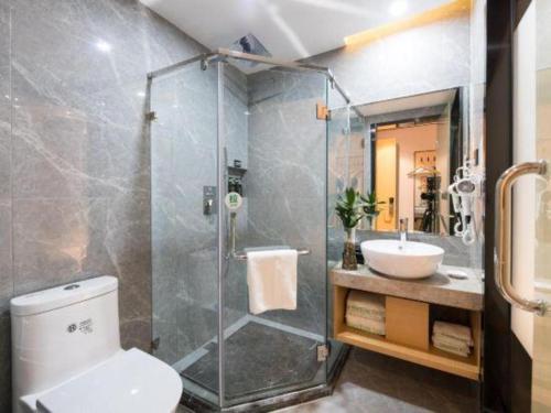 a bathroom with a shower and a toilet and a sink at Green Tree Inn Express Fuzhou Three Lanes and Seven Alleys Nanmendou Metro Station in Fuzhou