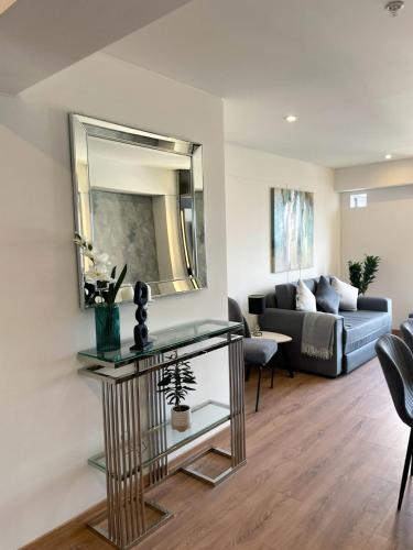 a living room with a couch and a mirror at Ocean view 1 BR Miraflores with parking in Lima
