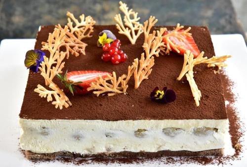 a chocolate cake with seaweed on top of it at Kempinski Hotel Grand Arena Bansko in Bansko