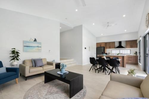 a living room with a couch and a table at Belle Escapes Sea Bon in Trinity Beach