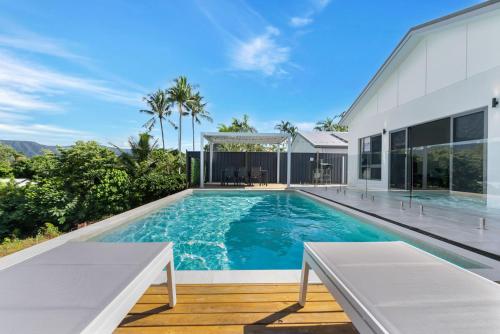 a swimming pool in the backyard of a house at Belle Escapes Sea Bon in Trinity Beach