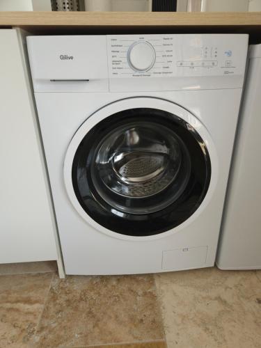 a white washing machine sitting under a counter at Havre de paix climatisé vers Gordes - Spa & nature in Beaumettes