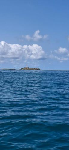 an island in the middle of a body of water at Kot Nou - Kwizine Mama Manze Lakaz in Mahébourg