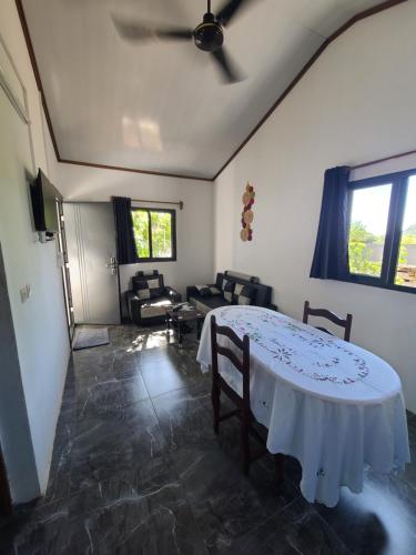 a living room with a table with chairs and a ceiling at Seromue in Diego Suarez