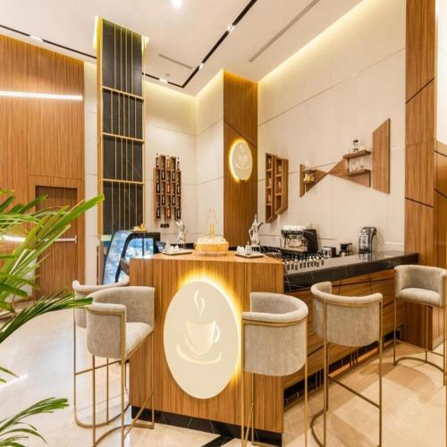 a kitchen with a table and some chairs at Sunday Luxury Central formerly Anan hotel in Riyadh