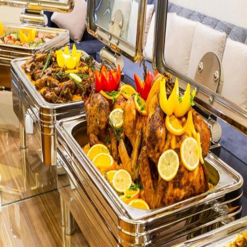 a buffet of food with chickens and other foods at Sunday Luxury Central formerly Anan hotel in Riyadh