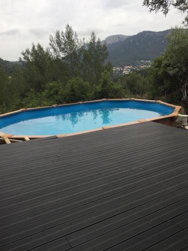 une grande piscine bleue sur le toit dans l'établissement Studio provençal avec terrasse et vue, à Le Revest-le-Eaux