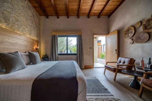 a bedroom with a large bed and a window at Casa Olivea in Valle de Guadalupe