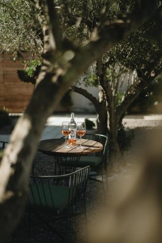 two glasses of wine sitting on a table at Casa Olivea in Valle de Guadalupe