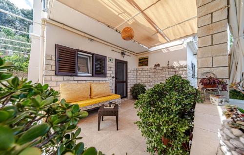 a patio with a yellow couch on a building at 2 Bedroom Amazing Home In Vela Luka in Vela Luka