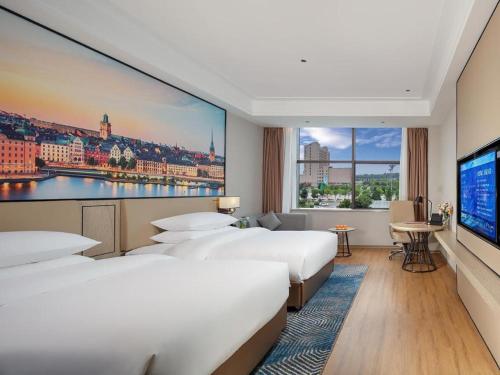 Postel nebo postele na pokoji v ubytování Vienna Hotel Shaanxi Xiianyang Yangling South Station