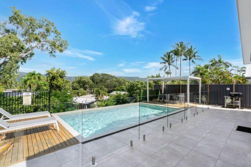 a swimming pool on the roof of a house at Belle Escapes Sea Bon in Trinity Beach