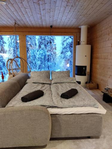 a large bed in a room with a large window at Villa Huikonen in Syöte