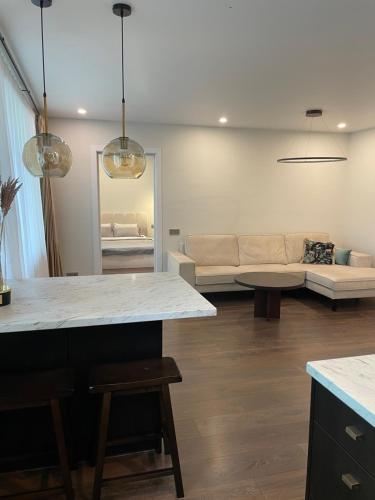 a living room with a couch and a table at Centro apartamentai in Biržai