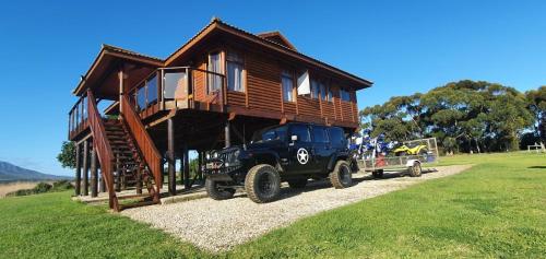 a black truck parked in front of a tiny house at Rivers End Farm Stanford with solar energy in Stanford