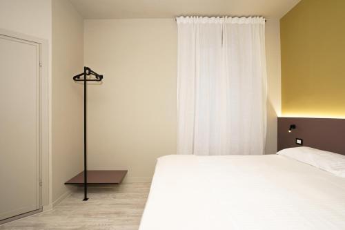 a bedroom with a white bed and a window at Mario house Assisi in Assisi