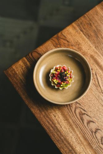 a plate of food on a wooden table at Casa Olivea in Valle de Guadalupe