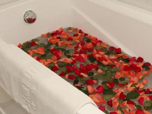 Una bañera blanca llena de flores rojas sobre un pastel. en Saigon Star Hotel, en Ho Chi Minh