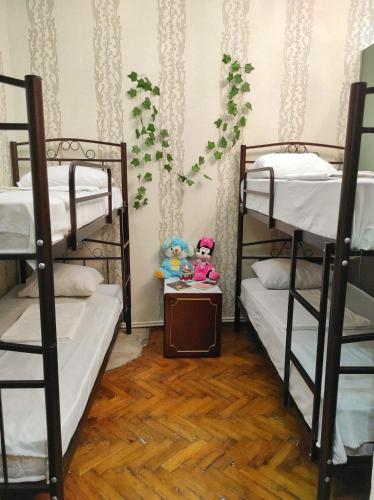 a room with two bunk beds and two dolls at Sweet Home & Hostel in Baku