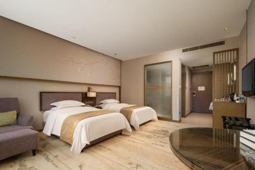 Zhangjiagang Guomao Hotelにあるベッド