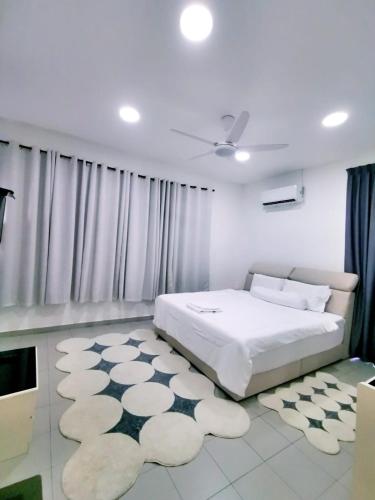 a bedroom with a bed and a large rug at Three Homestay in Perai