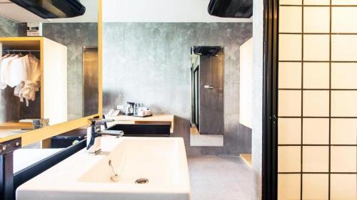 a bathroom with a white sink and a mirror at B2 Phuket Boutique & Budget Hotel in Patong Beach