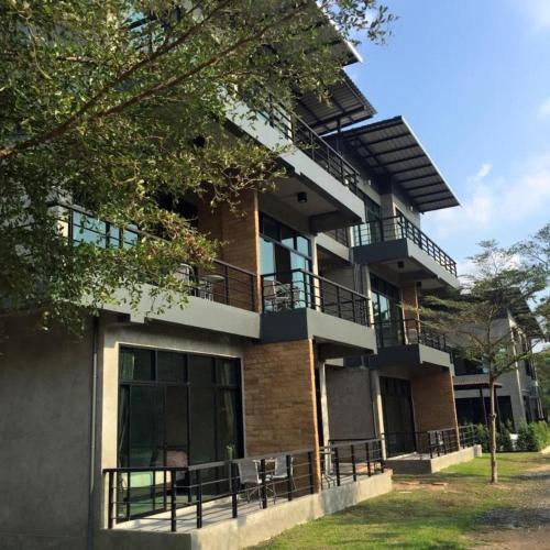 a building with balconies on the side of it at Ma-Kham Forest Resort in Nakhon Nayok