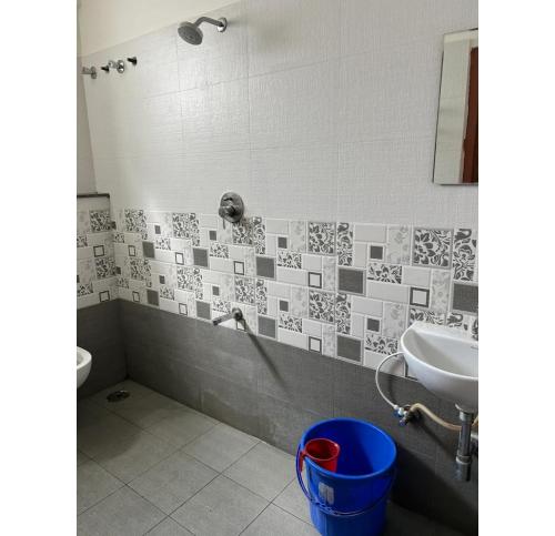 a bathroom with a sink and a toilet at Sai Bliss Residency, Manyata Tech Park in Bengaluru
