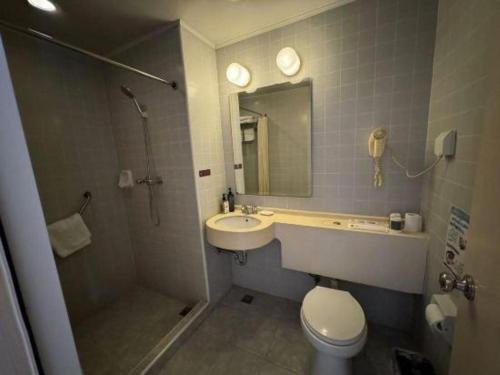 a bathroom with a sink and a shower and a toilet at Jinjiang Inn Nanjing Xinjiekou in Nanjing