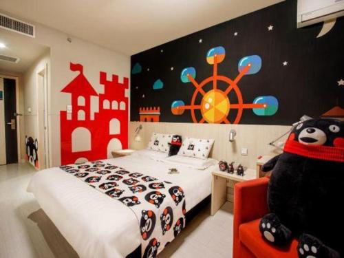 a bedroom with a large bed with a pirate ship wall at Jinjiang Inn Baotou Donghe East Railway Station in Baotou
