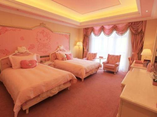 a hotel room with two beds and a window at Yin Run Jin Jiang Castle Hotel in Huzhou