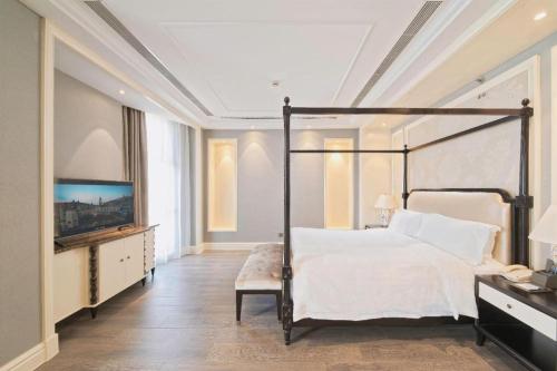 a bedroom with a bed and a large window at Yin Run Jin Jiang Castle Hotel in Huzhou