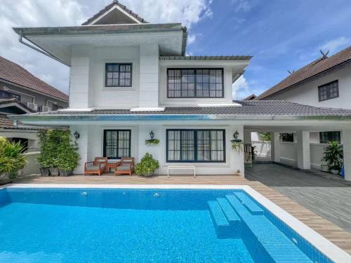a house with a swimming pool in front of it at LakeLyn Pool Villa 5BR , Close to Nimman in Chiang Mai
