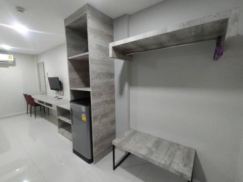 a room with a desk and a bench in a room at Sattahip 9 Boutique Hotel in Pattaya Central