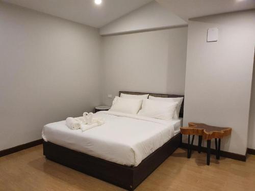 a bedroom with a bed with two stuffed animals on it at THE S VILLAS HOTEL in Nakhon Phanom