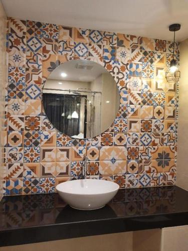 a bathroom with a sink and a mirror at THE S VILLAS HOTEL in Nakhon Phanom
