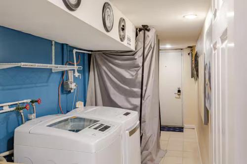 a hospital room with a washing machine in a room at Staycation Suite in Philadelphia